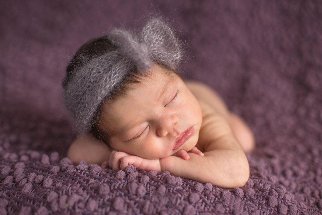 Newborn Evalynn sleeping on purple blanket by Pueblo Photographer K.D. Elise Photography.