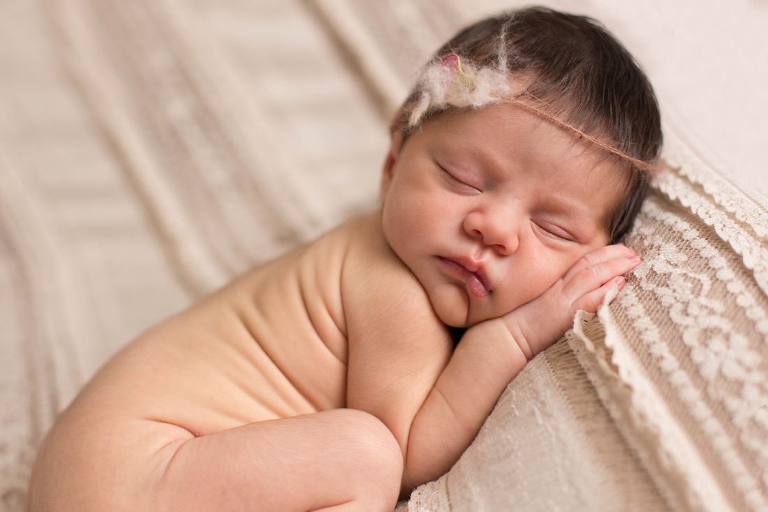 Sleeping newborn baby girl on lace blanket by Pueblo newborn photographer. 